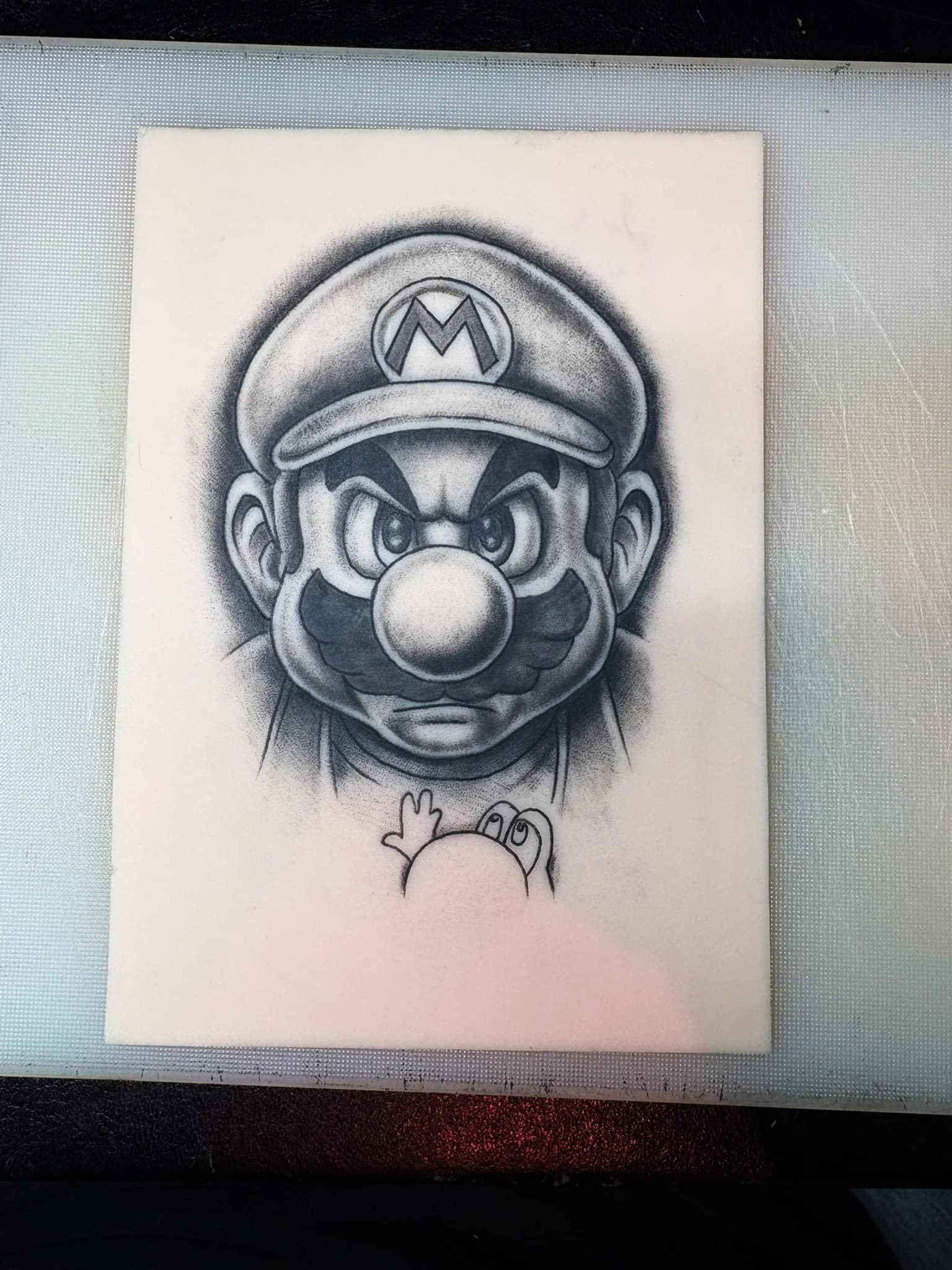 Synthetic skin tattoo practice of Mario with solid linework and fill shading.